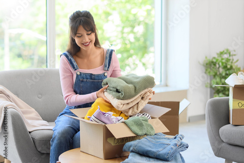 Young woman packing clothes...