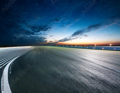 empty racing track at night under dramatic lighting
