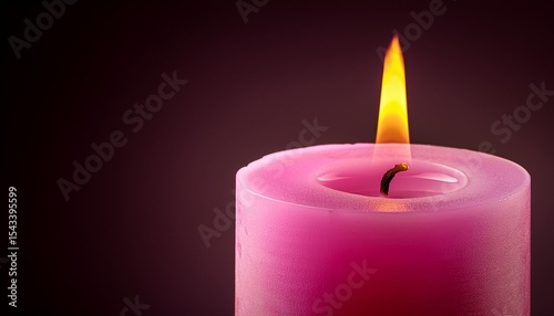 one bright flame shining on a pink candle