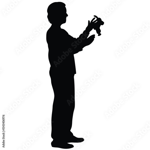 Silhouette of a person holding a small object in their hands carefully