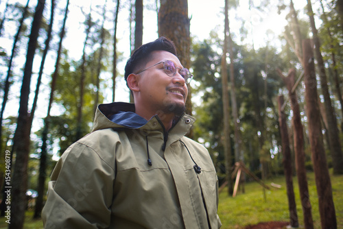 Smiling Man Enjoying Nature in a Calm Forest Environment