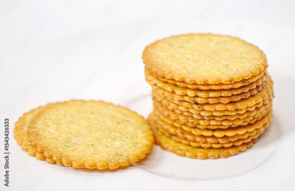 Thin round biscuits crackers stacked together close-up, Sweet and tasty round butter crackers. Thin round biscuits crackers stacked together close-up, Sweet and tasty round butter crackers.