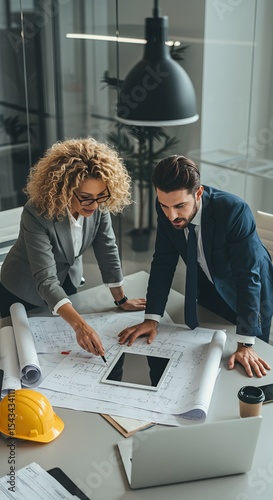 Business Team Combining Digital and Paper Planning Tools
