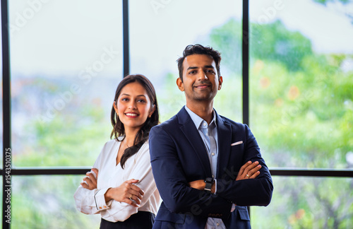 Posing with success and smiling confidently, Indian business professionals stand in office together