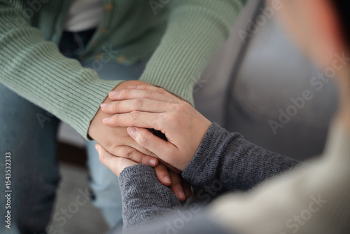 Psychologist, friend or family holding hands to encourage patient with depression, anxiety, therapy