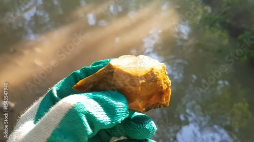 Inspection of a quartz specimen on flint found in a stream, rock and mineral search