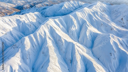 Wallpaper Mural Majestic snow-covered mountain ridges stretch across the serene landscape under a clear blue sky Torontodigital.ca