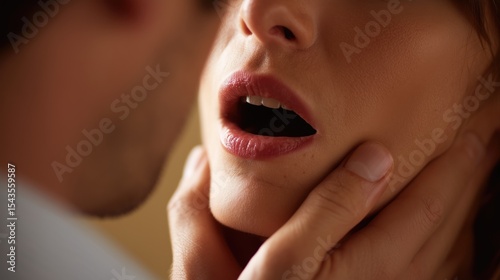 Man's hands gently holding a woman's neck creating a romantic atmosphere. Passionate couple. Sensuality. Female mouth, lips. Kiss