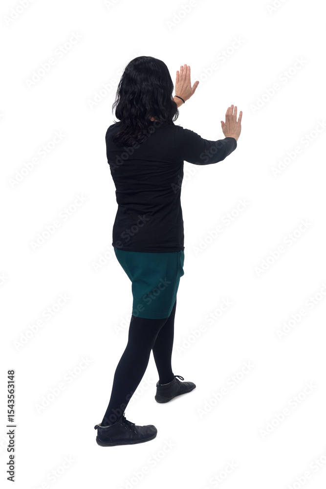 side back view of woman holding or squeezing a wall or something imaginary on white background side back view of woman holding or squeezing a wall or something imaginary on white background