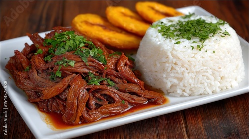Fototapeta Naklejka Na Ścianę i Meble -  Ropa vieja, traditional cuban dish featuring shredded beef, rice, and fried plantains
