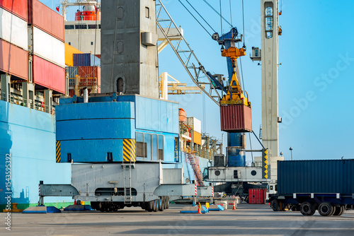 Container loading and unloading at the Port of Iquique, Chile, showing large cranes and a cargo vessel in action.