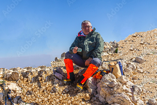 Hiker is posing at the summit of Kızlar Sivrisi Mountain (3070 m.) at Elmalı, Antalya, Turkey