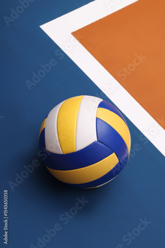 Volleyball on Wooden Court Floor Corner close up with light reflection with room for text or copy space