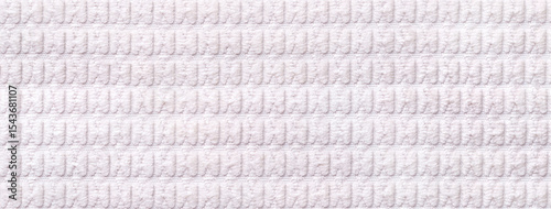 Texture of white soft velour textile with ribbed pattern, macro. Structure of plush fabric material backdrop