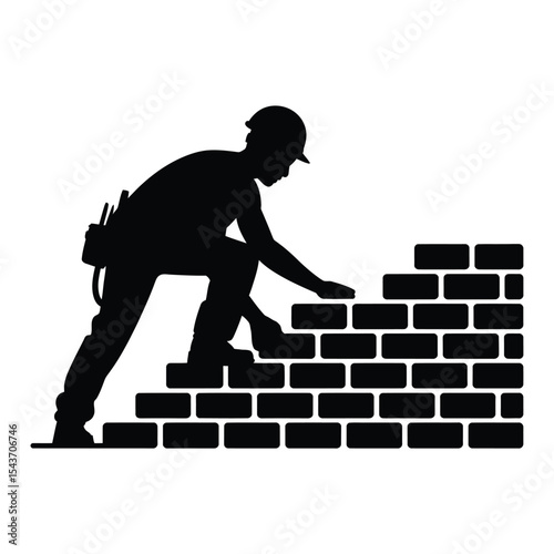 Silhouette of construction worker building brick wall