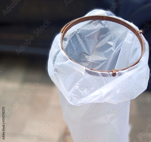 modern dustbin with plastic liner, minimalist trash bin setup, clean waste bin closeup, white garbage bag in hoop, sanitation concept photo, hygienic waste solution, plastic liner detail image, event