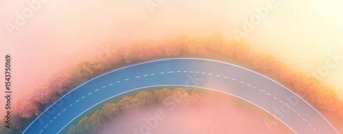 Aerial view of winding road through misty landscape.