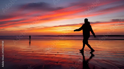 Golden Hour Stroll: Silhouette Figures on a Beach Sunset