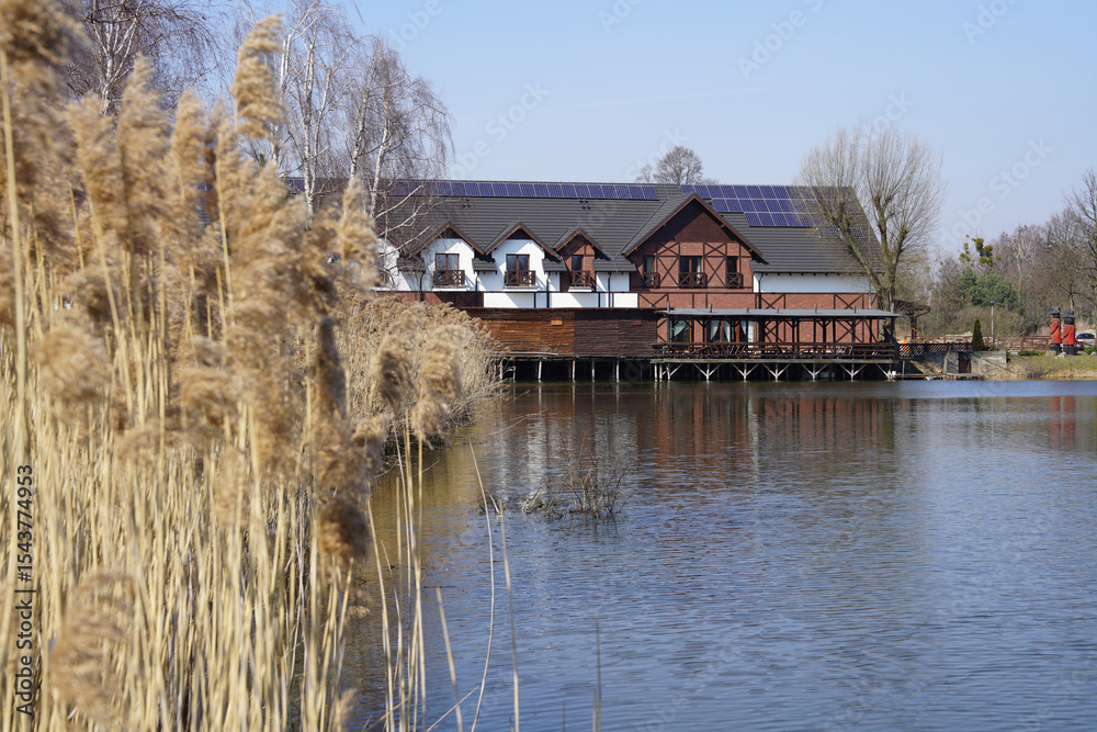 Fototapeta premium Przygodzice, Górecznik, Greater Poland; Reeds and a guesthouse by the lake; house on the lake
