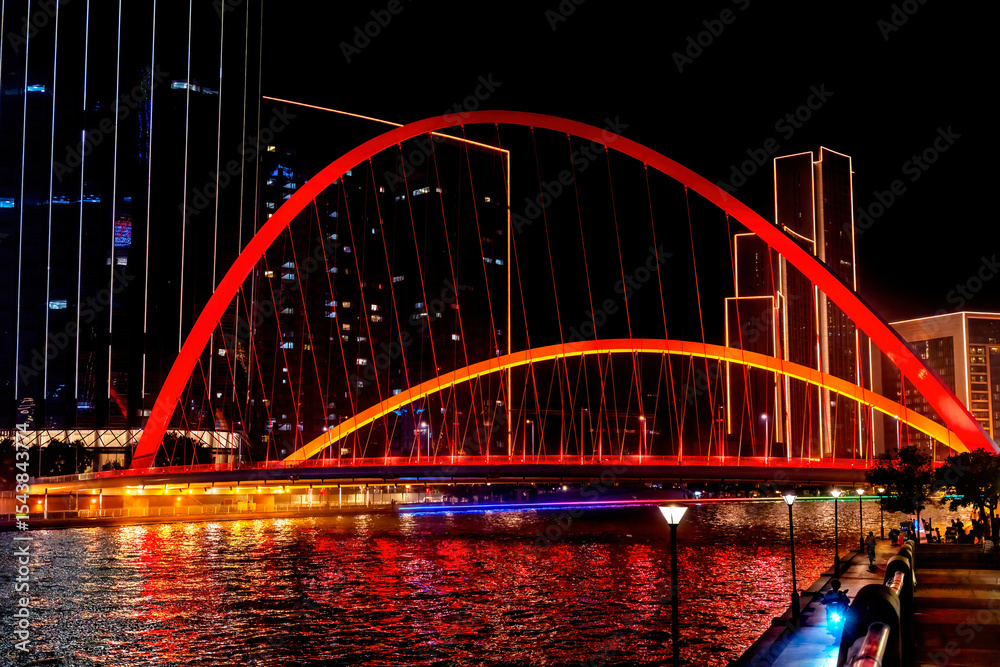 Obraz premium Tianjin World Financial Center, Dagu Bridge, old buildings and Illuminated Hai River, Tianjin, China. Built in 2005. Pedestrian walkway.