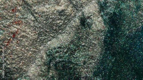 Shimmering macro background with gray and green tones. Sparkling texture with fine glitter particles perfect for design backgrounds.