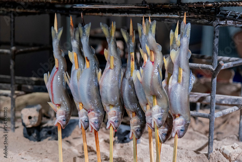 Smoking fish on skewers, Tsukiji Market, Tokyo, Japan