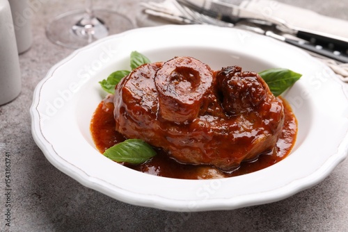 Konstfotografi Traditional ossobuco dish with beef steak served on grey table, closeup