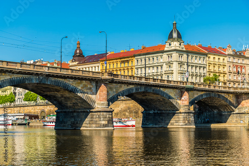 A view from the Vltava river towards the southern side of the Palacke bridge in Prague in springtime