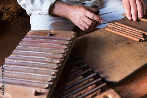 Cuba, Vinales Valley. Tobacco farm, cigar production. Cigar being rolled.