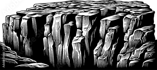 Dramatic rocky cliff face with vertical cracks in black and white design for earth texture