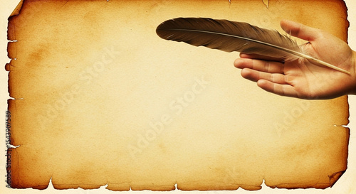 A hand holding a quill over aged parchment paper with burnt edges creating a vintage aesthetic look