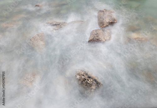 Spain, Playa de Aguilar. Rocks in ocean shore water.
