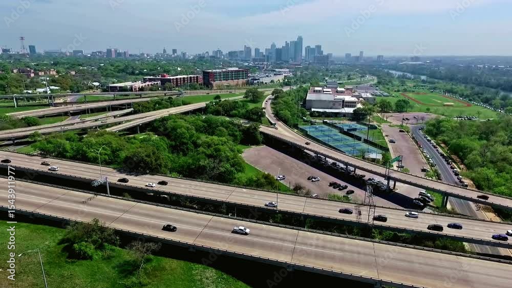 Elevated View of Urban Freeway Interchange and City Skyline Elevated View of Urban Freeway Interchange and City Skyline