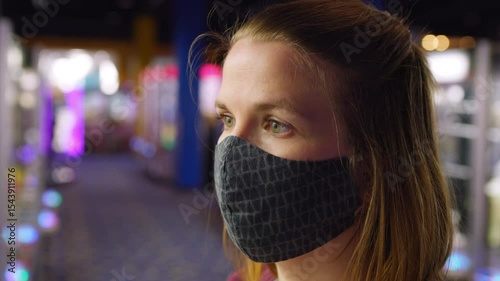 Young girl wearing mask in arcade 4k
