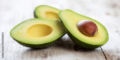 Freshly sliced avocados display their vibrant green flesh and rich texture, ready for consumption.