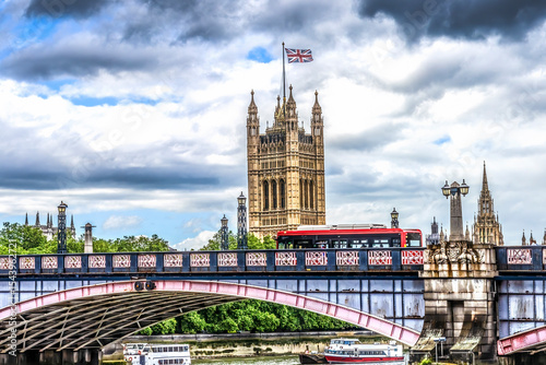 Red bus, houses of Parliament, Thames River, Lambeth Bridge, Westminster, London, England. Built in the 1800's, House of Commons and House of Lords. photo