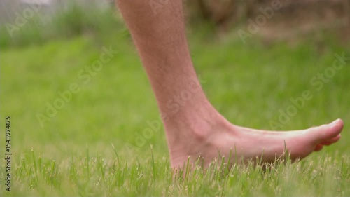 Bare feet walking through grass slow motion 4k
