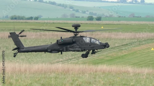 a dark grey helicopter in low level flight