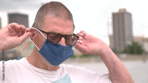 Elderly man removes face mask after covid virus slow motion
