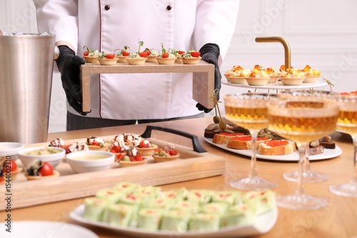 Chef arranging appetizers on buffet table, closeup