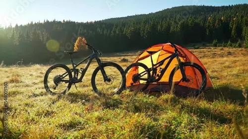 Scenic Autumn Sunrise Over Mountain Meadow Featuring Bikes and Tent