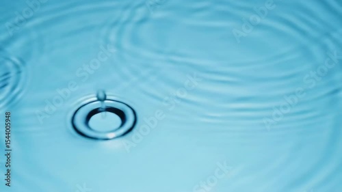 Super Slow Motion of Water Surface Ripples on Light Blue Background with Clear Fluid Dynamics
