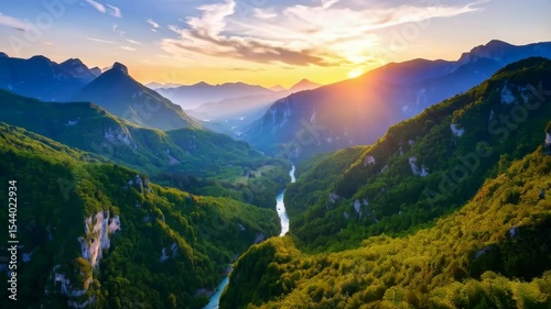 Spectacular sunrise view over a winding river flowing through lush forested mountains in an idyllic natural setting.