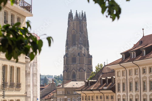  Fribourg Cathedral Tower Looming Over Historic City Buildings