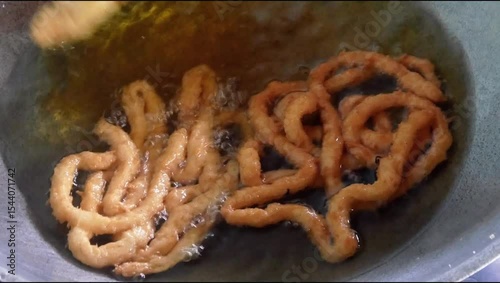 cooking or making traditional Indonesian coconut root cake by frying it in a pan