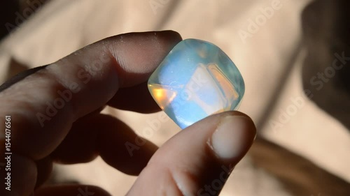 hand holding a crystal ball Opaline glass gem at sun