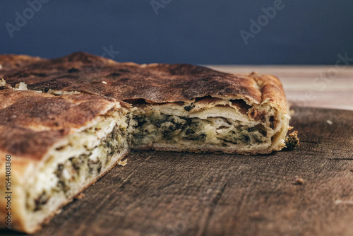 a warm  flaky slice of byrek  savory pie