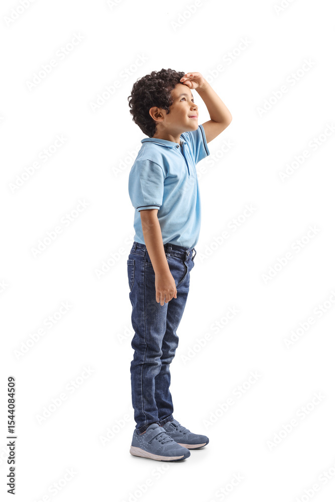 Naklejka premium Full length profile shot of a boy looking up