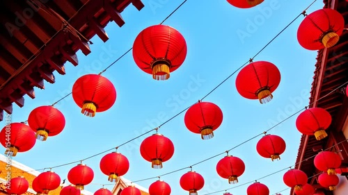 Celebration of tradition in a vibrant place adorned with hanging red lanterns under a clear blue sky