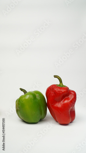 Sweet pepper, green, red paprika on white background